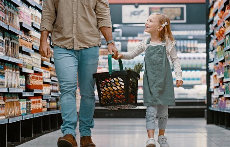 Father and daughter shopping in a modern supermarket near Anketell, showcasing the convenience and lifestyle benefits of living in Catena Estate